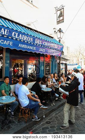 PARIS , France- June 01, 2017: View of typical paris cafe in Paris. Montmartre area is among most popular destinations in Paris, Au clairon de chasseur is a typical cafe.