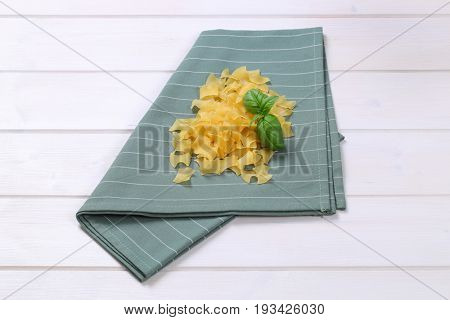 pile of quadretti - square shaped pasta on grey place mat