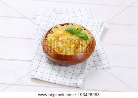 bowl of quadretti - square shaped pasta on checkered dishtowel