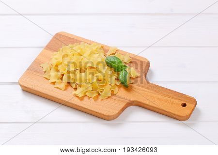 pile of quadretti - square shaped pasta on wooden cutting board