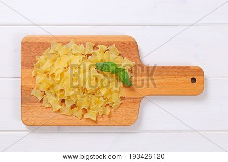 pile of quadretti - square shaped pasta on wooden cutting board