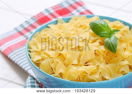 bowl of quadretti - square shaped pasta on checkered place mat - close up