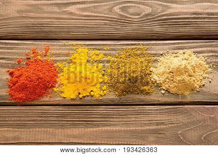 Spice powder on a wooden background. Close-up. Top view.