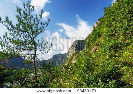 A low hanging cloud against blue sky in the early morning at Fangdong Scenic Area on Yandangshan mountains located in Zhejiang province China.