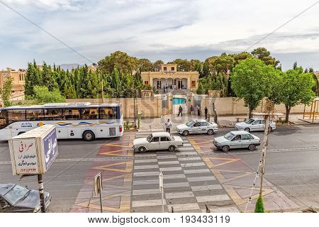 YAZD, IRAN - MAY 5, 2015: Cars passing on Kashani Rd in front of the fire temple Atash Behram in old city.