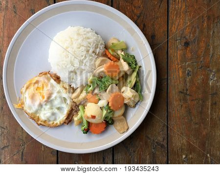 Mixed Fried Vegetable Tofu With Rice And Fried Egg In White Dish On Wooden Background. Vegetarian Fo