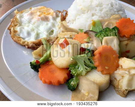 Mixed Fried Vegetable Tofu With Rice And Fried Egg In White Dish On Wooden Background. Vegetarian Fo