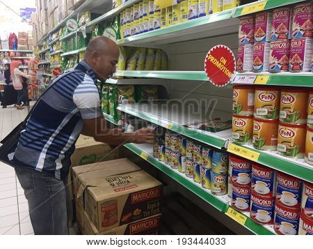 Keningau,Sabah-June 23,2017:Men choose household goods in a large store of Giant Malaysian Supermarket in Keningau,Sabah.Giant,pioneered the concept of modern supermarket shopping.