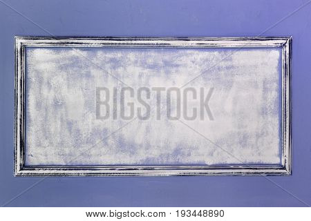 White empty antique frame made of gypsum in the Renaissance style. The wall is turquoise. Background.