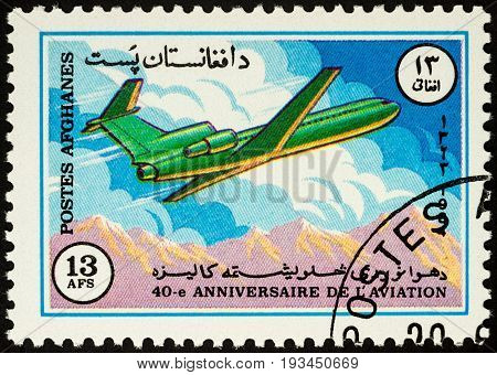 Moscow Russia - April 14 2017: A stamp printed in Afghanistan shows flying passenger airliner over mountains series 