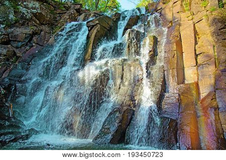 a beautiful waterfall in the forest. Wildlife, waterfalls in a deserted forest. taiga. strong and tall waterfall in forest