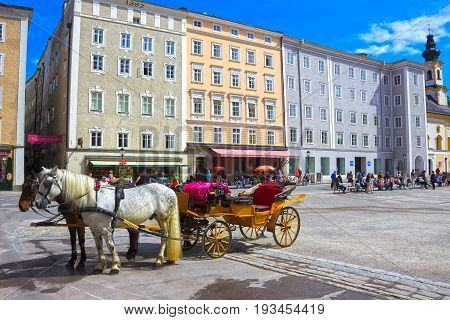 Salzburg, Austria - May 01, 2017: Central place in Salzburg city , Austria with carriages and horses at Salzburg, Austria on May 01, 2017