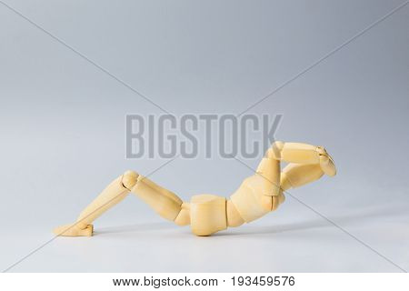 Wooden figure doll with sit up for health on white for exercise training and helth concept.