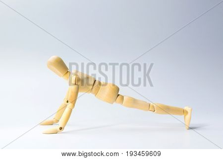 Wooden figure doll with push up for health on white for exercise training and helth concept.