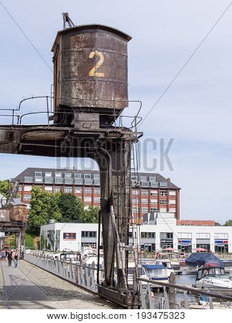 BERLIN GERMANY - JUNE 21 2017: Old Wooden Crane In Tempelhofer Hafen Meaning Harbor of Tempelhof In German Language In Berlin