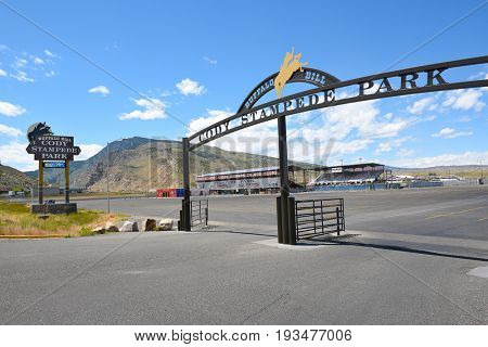 CODY, WYOMING - JUNE 24, 2017: Cody Stampede Park entrance arch and arena. Cody is the Rodeo Capitol of the World. 2017 marks 79th anniversary of nightly performances.