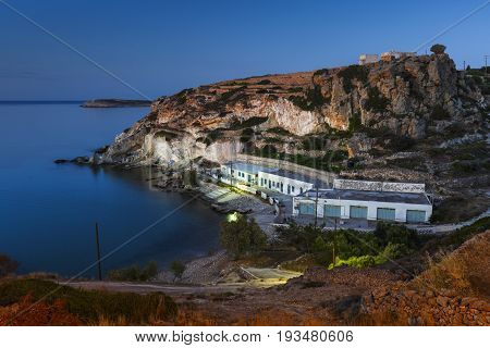 Boat houses in fishing village of Goupa on Kimolos island in Greece.