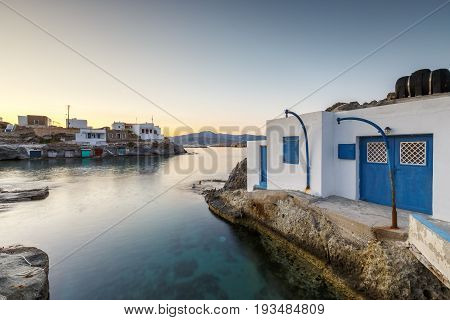 Boat houses in fishing village of Goupa on Kimolos island in Greece.