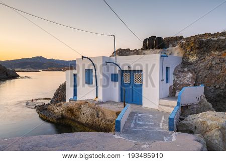 Boat houses in fishing village of Goupa on Kimolos island in Greece.