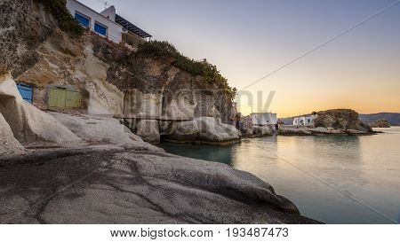 Boat houses in fishing village of Goupa on Kimolos island in Greece.