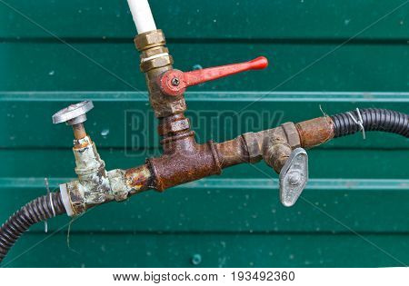 Connection hoses old rusty plumbing valves .