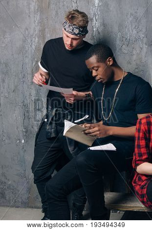 Group of graduates preparing for the exam. Ghetto scientists are engaged in science. Illegal immigran's education, self-development, distance education, social problems concept