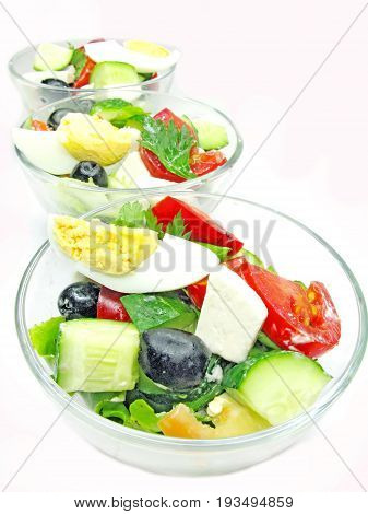 greek salad with cheese olive and tomato in three portion bowls