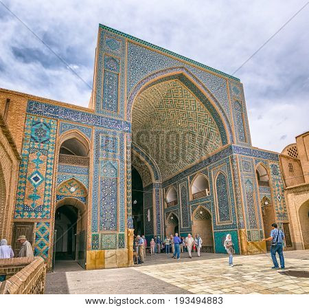 YAZD, IRAN - MAY 5, 2015: Group of tourists visiting the Yame mosque in old city.