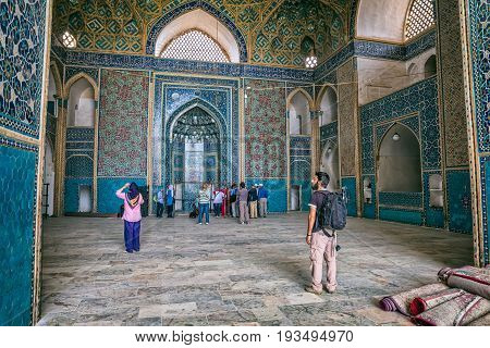 YAZD, IRAN - MAY 5, 2015: Group of tourists visiting the Yame mosque in old city.