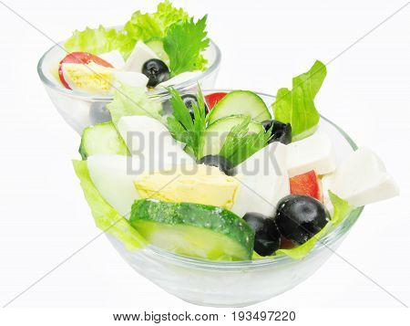 two bowls of greek salad with cheese olive and tomato