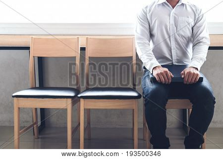 interview recruitment concept Businessman holdind portfolio report while sitting on chair. Tired of waiting Human Resources Waiting for interview.