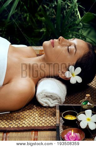 portrait of young beautiful woman relaxing in spa environment