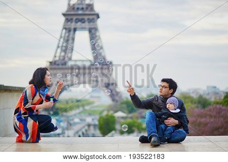 Happy Family Of Three In Paris Near The Eiffel Tower