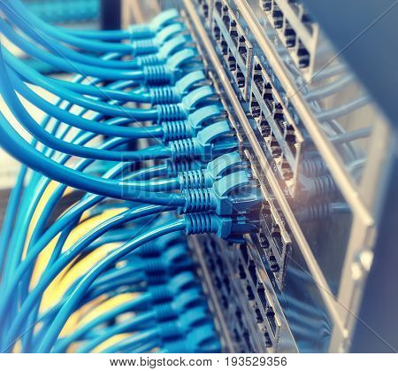 Network cables in switch and firewall in cloud computing data center server rack