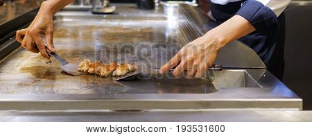 Hand Of Chef Cooking Chicken Steak