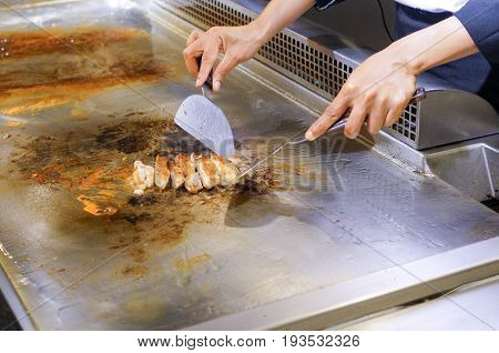 Hand Of Chef Cooking Chicken Steak