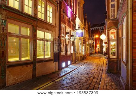 Medieval Bremen street Schnoor with half-timbered houses in the centre of the Hanseatic City of Bremen at night, Germany