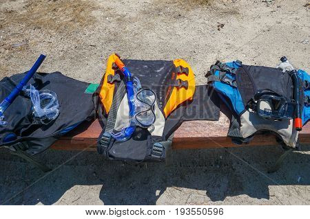 Labuan,Malaysia-May 1,2017:Various of life vests or life jackets is hung for drying out in Rusukan Besar island,Labuan,Malaysia.It is filled with buoyant material and used as a life preserver.