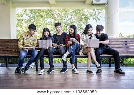 Educational process. Group of asian young people studying in university sitting on chair education students college university studying friendship teenager concept