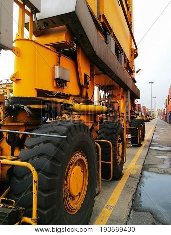 Close Up Wheel Rubber Tried Gantry Cranes (RTG) At Industrial Port