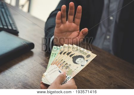 Businessman rejecting money - anti bribery concept