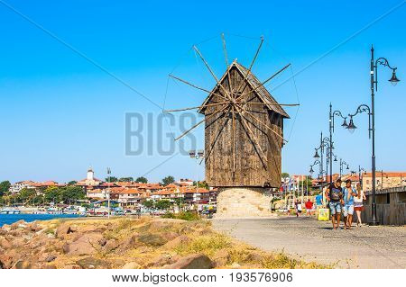 Nessebar, Bulgaria - July 25, 2016: Windmill, tourists and old town panorama in Nessebar or Nesebar in Bulgaria, Black sea