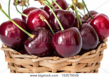 Full basket of sweet red cherries on a stem close up macro