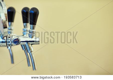 close-up of barman hand at beer tap pouring a draught lager beer