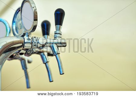 close-up of barman hand at beer tap pouring a draught lager beer