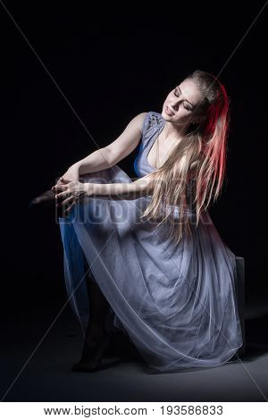 Actress In A Grey Dress On A Dark Stage