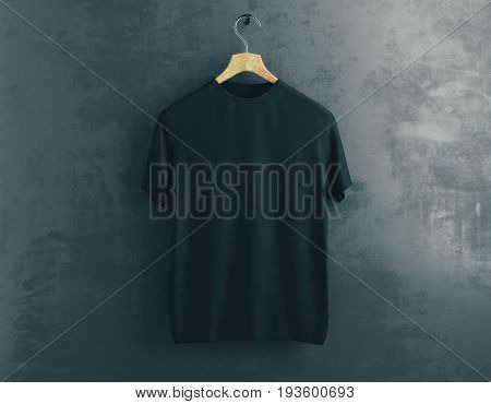 Wooden hanger with empty black t-shirt hanging on dark concrete background. Clothes concept. Mock up. 3D Rendering