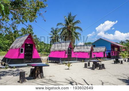 Labuan,Malaysia-May 1,2017:Colourful resort chalets with beautiful sandy beach at Rusukan Besar island in Labuan,Malaysia.It is a popular place for tourist to visit & snorkeling underwater in Labuan