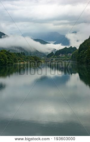 Mountain River Landscape In The Morning With Low Clouds And Fog