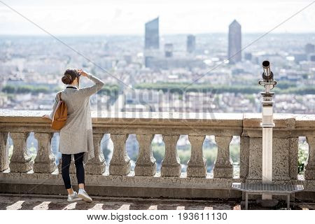 Woman enjoying great view on Lyon city with skyscrapers during the morning in France